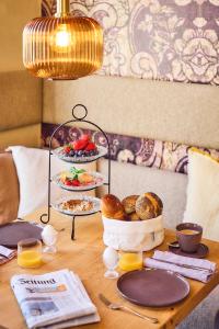 a table with plates of food on top at Hotel Lahneck in Nievern +11 photos