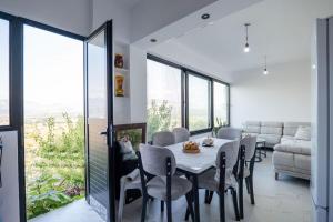 a dining room with a table and chairs and a couch at Lina's House in Sarandë