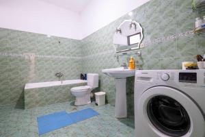 a bathroom with a washer and a washing machine at Lina's House in Sarandë +45 photos