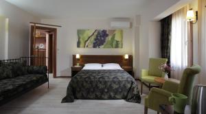 Postel nebo postele na pokoji v ubytování Mitos Hotel