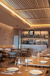 a restaurant with wooden tables and chairs and a bar at Blue Malva in Valencia