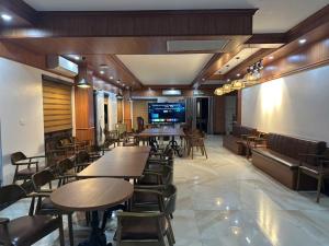 a restaurant with tables and chairs in a room at Khách Sạn Ka Long in Móng Cái