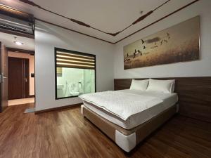a bedroom with a large bed and a window at Khách Sạn Ka Long in Móng Cái +15 photos