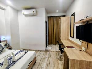 a hotel room with a bed and a television at Hotel Annex International Near International Airport in Mumbai +27 photos