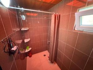 a bathroom with a shower with a shower curtain at Hotel Liza in Batumi +43 photos