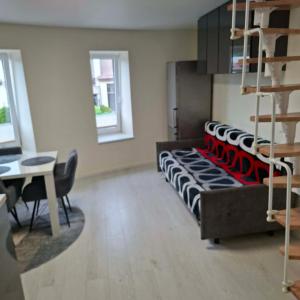 a living room with a couch and a table at Melnaragė in Melnragė