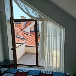 a window with a view of a roof at Melnaragė in Melnragė