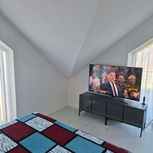 a room with a flat screen tv on a wall at Melnaragė in Melnragė