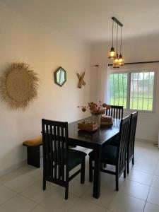 a dining room with a black table and chairs at Nyumba Nzuri in Ukunda, Diani in Ukunda