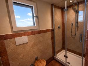 a bathroom with a shower and a window at Capozucca Home in Città della Pieve