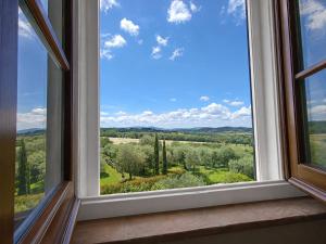 a window with a view of the countryside at Capozucca Home in Città della Pieve +18 photos