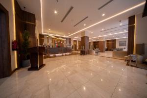 a large lobby with a large tile floor in a building at Continent Al Marzam in Medina +17 photos