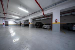 a large parking garage with cars parked in it at Continent Al Marzam in Medina