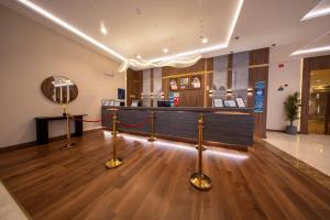 a hotel lobby with a counter and a bar at Continent Al Marzam in Medina