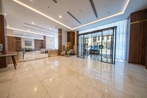a lobby of a building with a large glass door at Continent Al Marzam in Medina