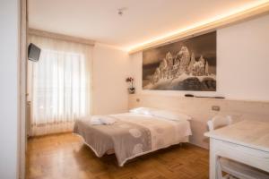 Postel nebo postele na pokoji v ubytování Albergo Meublè Victoria