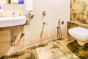 a bathroom with a sink and a toilet at Hotel Annex International Near International Airport in Mumbai
