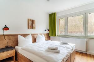 ein Schlafzimmer mit einem Bett mit weißer Bettwäsche und einem Fenster in der Unterkunft Bodeapartment 4 in Elend