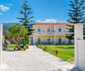a walkway leading to a large yellow building at Hector's studios in Kalamaki