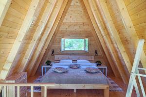 a bedroom in a log cabin with a bed at Wolf Ridge Mountain Cabin Montenegro in Plužine