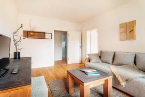 a living room with a couch and a table at Bodeapartment 8 in Elend +6 photos