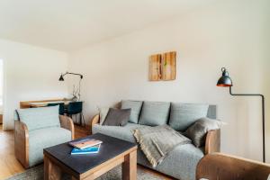 a living room with a couch and a table at Bodeapartment 3 in Elend +35 photos