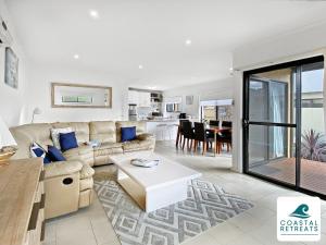 a living room with a couch and a table at Town & Tide, Cowes Central in Cowes