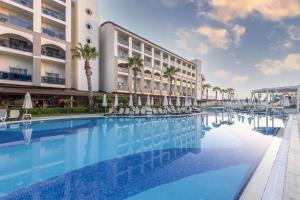 a large swimming pool in front of a building at LRS Hotels Port River Hotel & Spa - Ultra All Inclusive in Side
