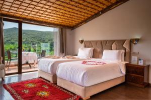 a bedroom with a large bed and a large window at Dar Zayane in Khenifra +75 photos