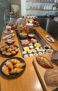 a table with many different types of bread and pastries at Chez Gilles Hôtel Restaurant SA in La Chaux-de-Fonds
