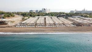 an aerial view of a beach with white umbrellas at LRS Hotels Port River Hotel & Spa - Ultra All Inclusive in Side