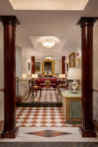 a living room with a couch and a table at The Britannia Hotel in Rome