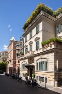 a building with motorcycles parked in front of it at The Britannia Hotel in Rome