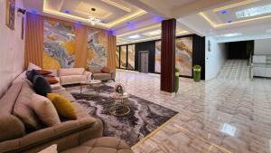 a large living room with a couch and a table at Hôtel Mandela Nouakchott in Nouakchott