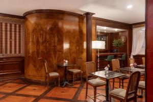 a room with wooden walls and tables and chairs at The Britannia Hotel in Rome