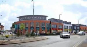 a building with a car parked in a parking lot at 1 Bed Apartment Sleeps 2 -Free Parking -WiFi & Tv in Sutton Coldfield +3 photos