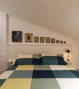 a bedroom with a bed with two pillows at Casa Olgaluna - Art Home in La Spezia