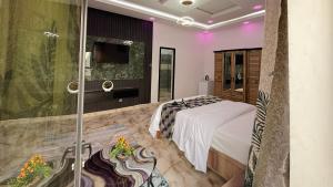 a bedroom with a bed and a glass shower at Hôtel Mandela Nouakchott in Nouakchott +75 photos