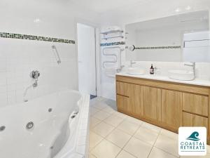 a white bathroom with a tub and a sink at Town & Tide, Cowes Central in Cowes +25 photos