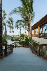 a balcony of a resort with palm trees at ENVI Paje Wellness Lodge in Paje