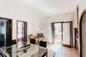 a living room with a glass table and chairs at Holiday Home Marina 9 in Portals Nous