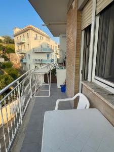 a balcony with a white bench on a building at A casa mia in Gaeta