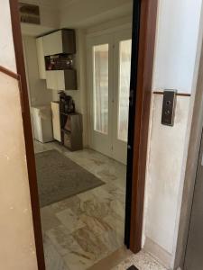 an open door to a room with a kitchen at A casa mia in Gaeta +6 photos