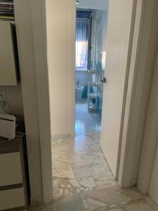 a room with a hallway with a tile floor at A casa mia in Gaeta
