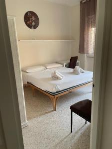 a bedroom with a bed and a chair in it at A casa mia in Gaeta