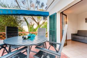 a blue table and chairs on a patio at Holiday Home Marina 9 in Portals Nous