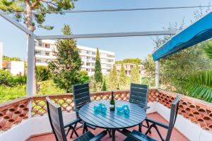 a patio with a table and chairs on a balcony at Holiday Home Marina 9 in Portals Nous