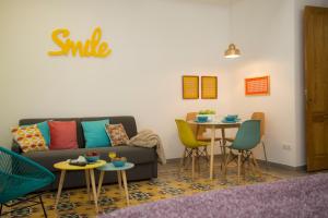 a living room with a couch and a table with chairs at Eco-Friendly Apartments in Valencia