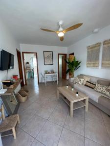 a living room with a couch and a table at Marenga in El Rompido