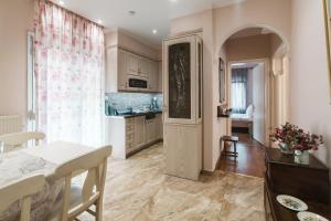 a kitchen with a table and a door leading into a kitchen at Angelikis Maisonette in Kastoria